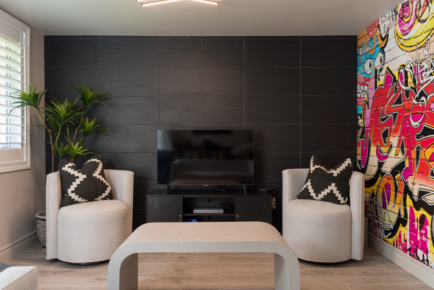 Finished basement media and lounge room with feature art wall in Toronto