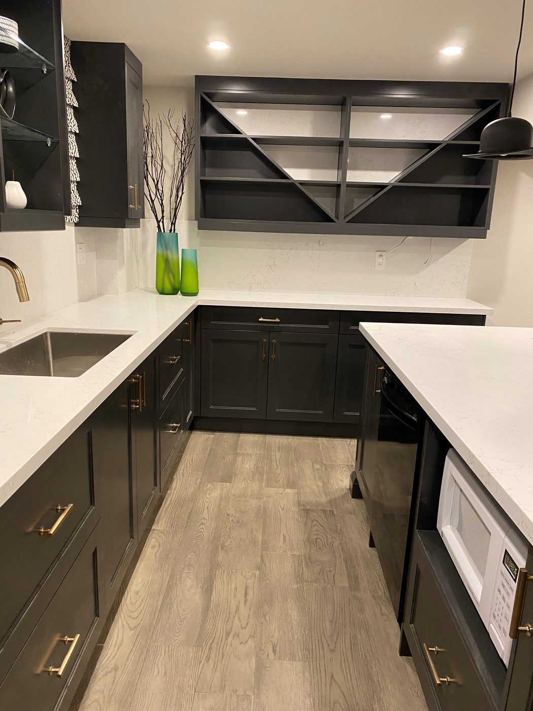 Basement apartment kitchen with white counters in a Toronto basement renovation