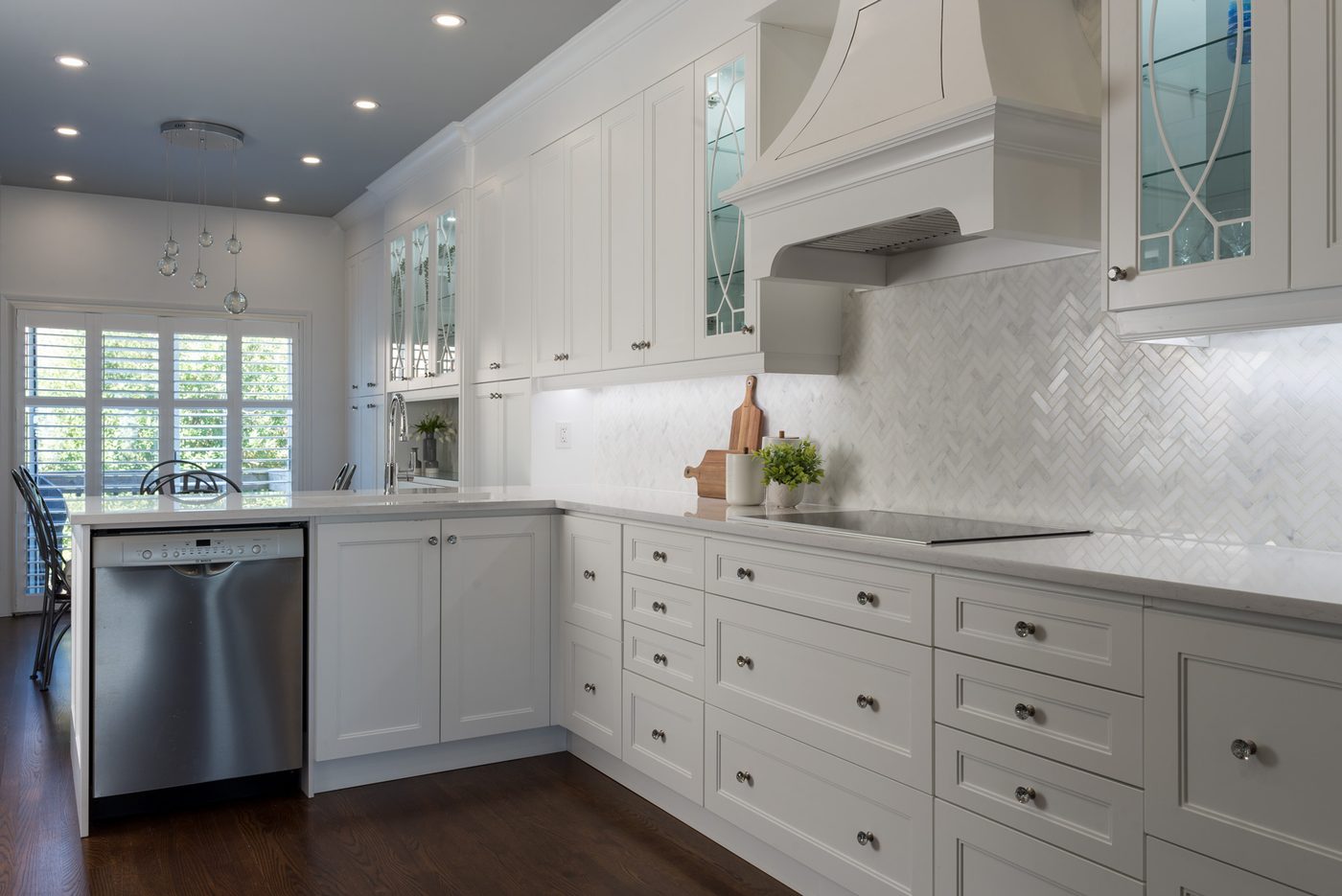 White shaker kitchen with chevron marble backsplash in a Toronto renovation