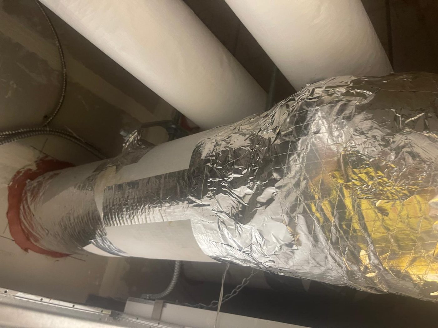 Basement pipe insulation and duct wrap detail in a Toronto mechanical room